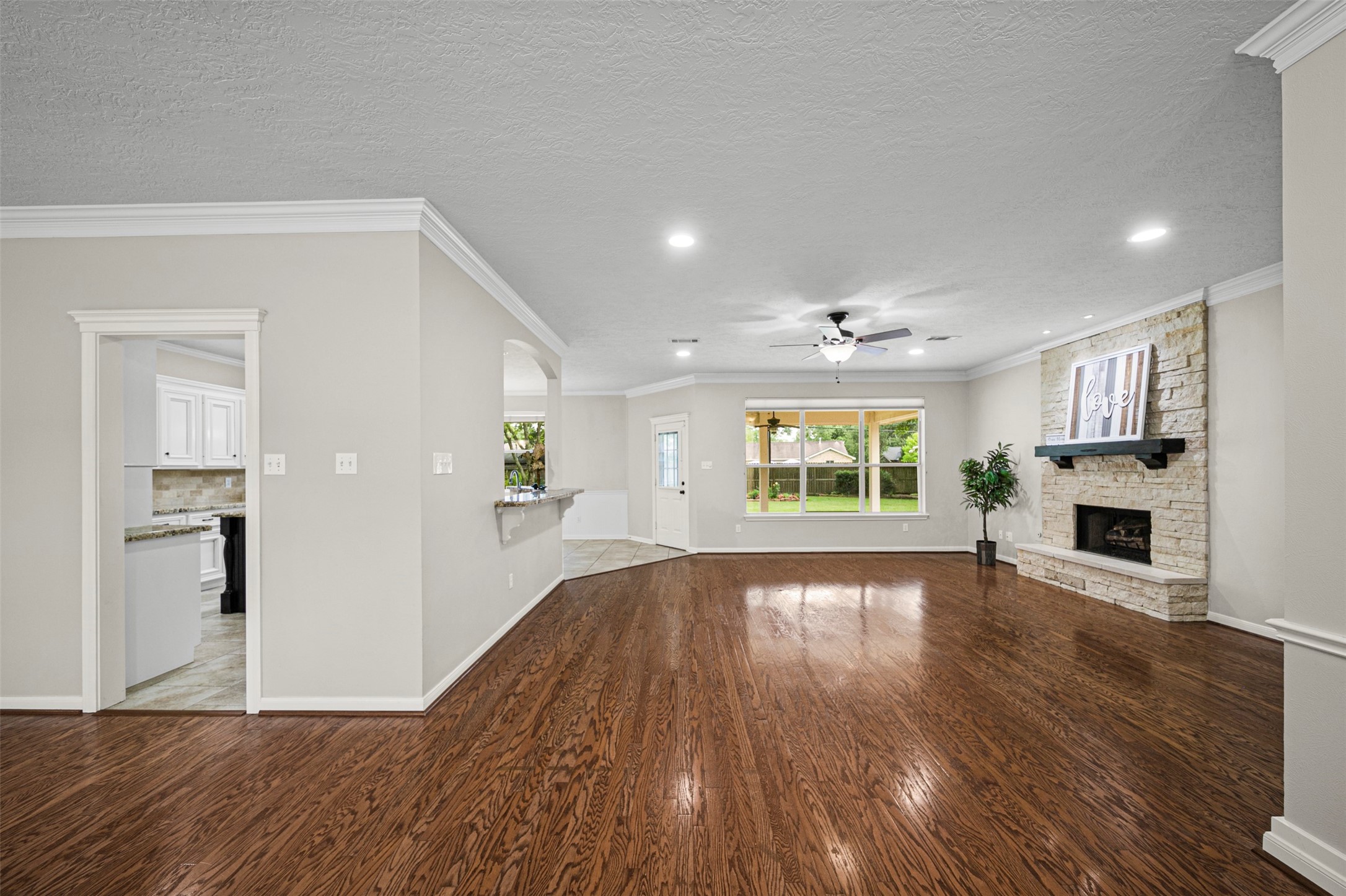 2452 Ripplewood Drive Conroe, TX 77384 - Photo 6 of 31 a view of empty room with wooden floor and fireplace