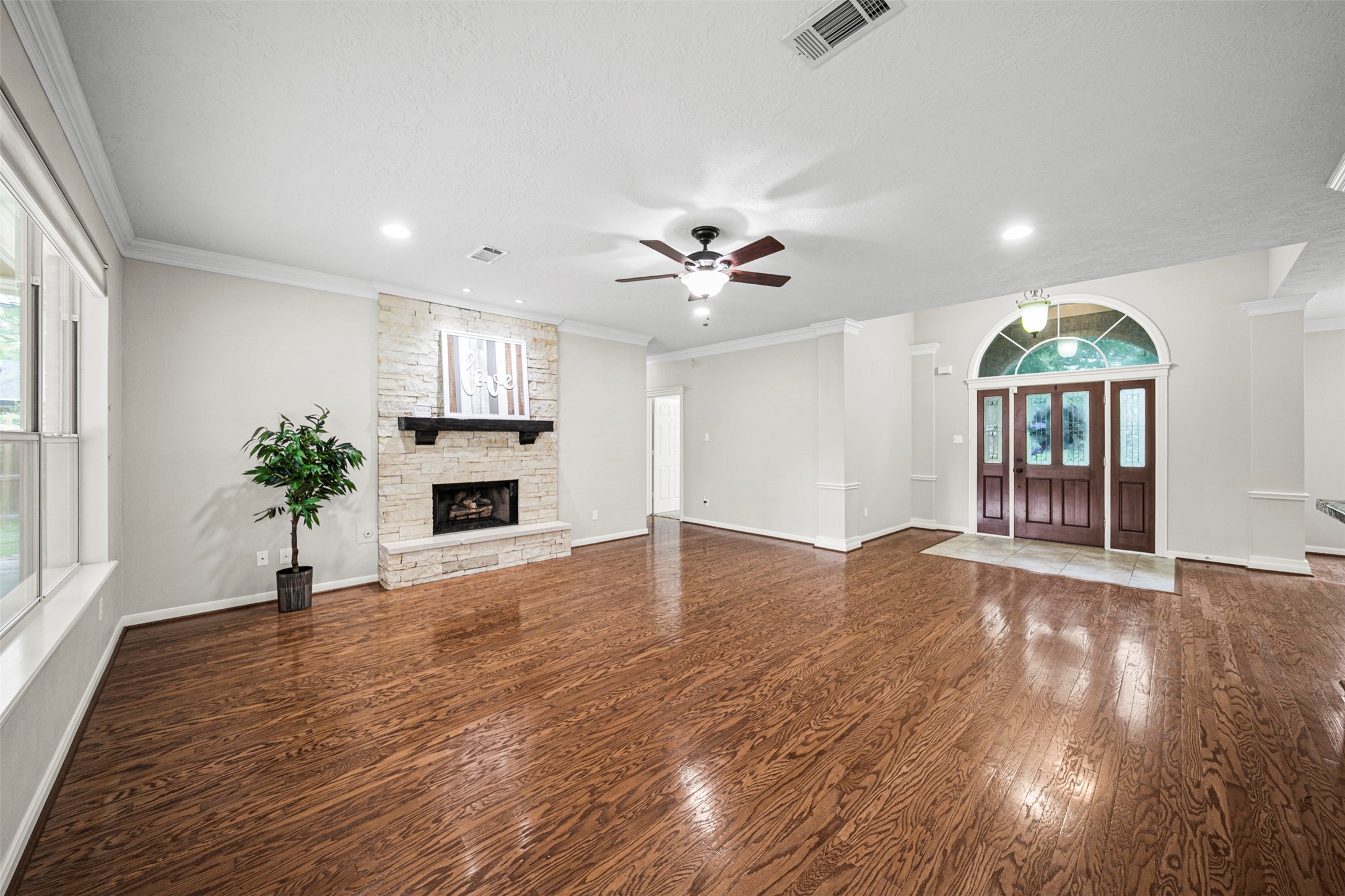 2452 Ripplewood Drive Conroe, TX 77384 - Photo 7 of 31 a view of a livingroom with a fireplace wooden floor and a window