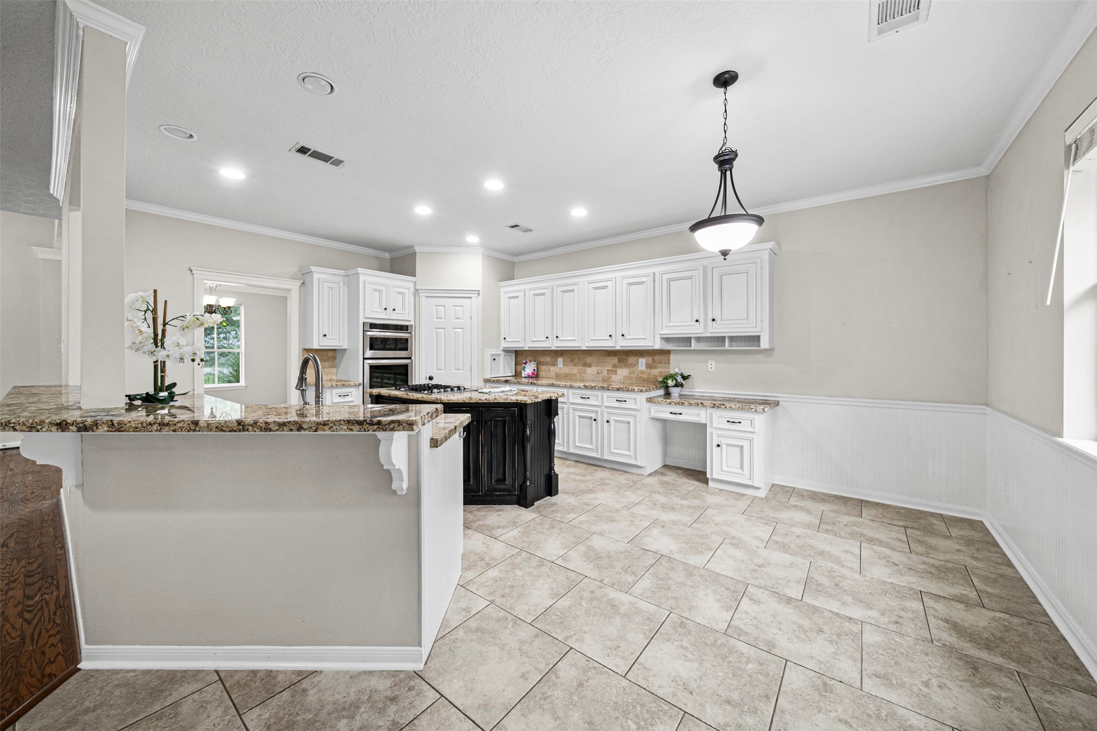 2452 Ripplewood Drive Conroe, TX 77384 - Photo 9 of 31 a kitchen with stainless steel appliances granite countertop a sink a stove a refrigerator and cabinets