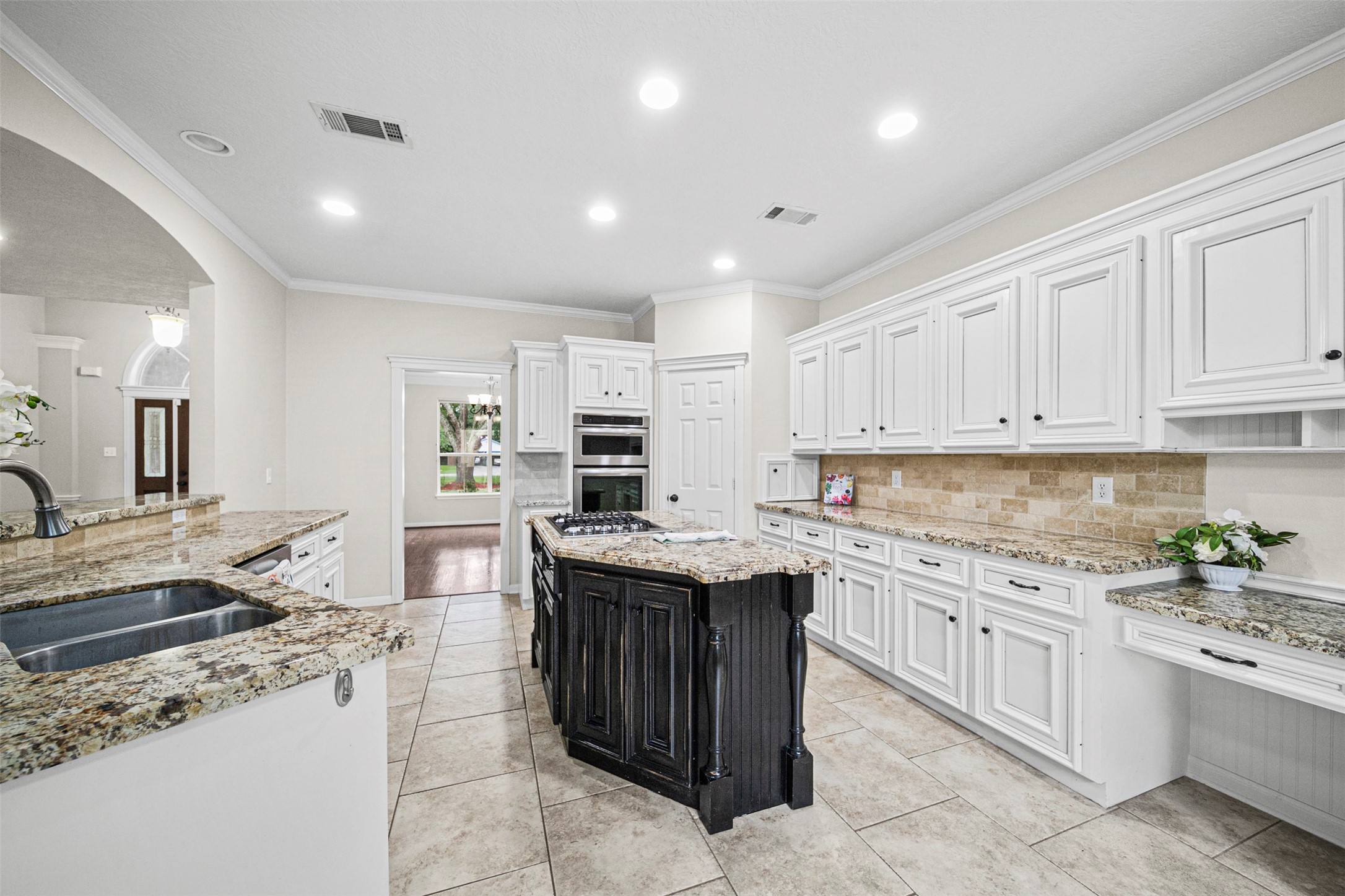 2452 Ripplewood Drive Conroe, TX 77384 - Photo 10 of 31 a kitchen with a sink stove and cabinets