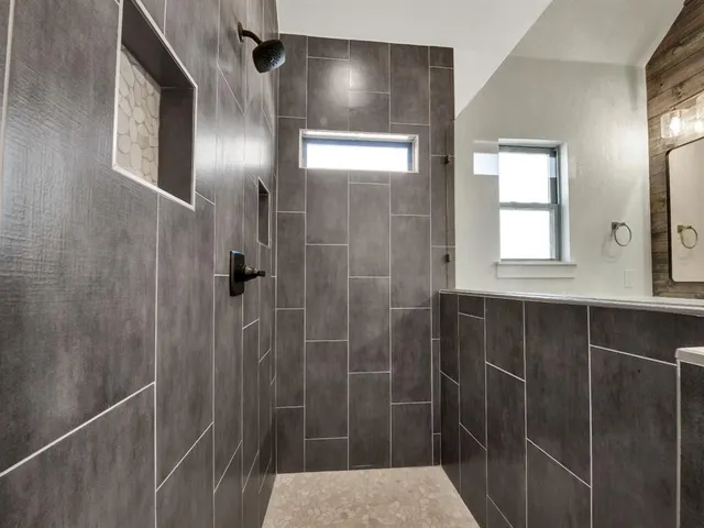 a bathroom with a shower and a sink