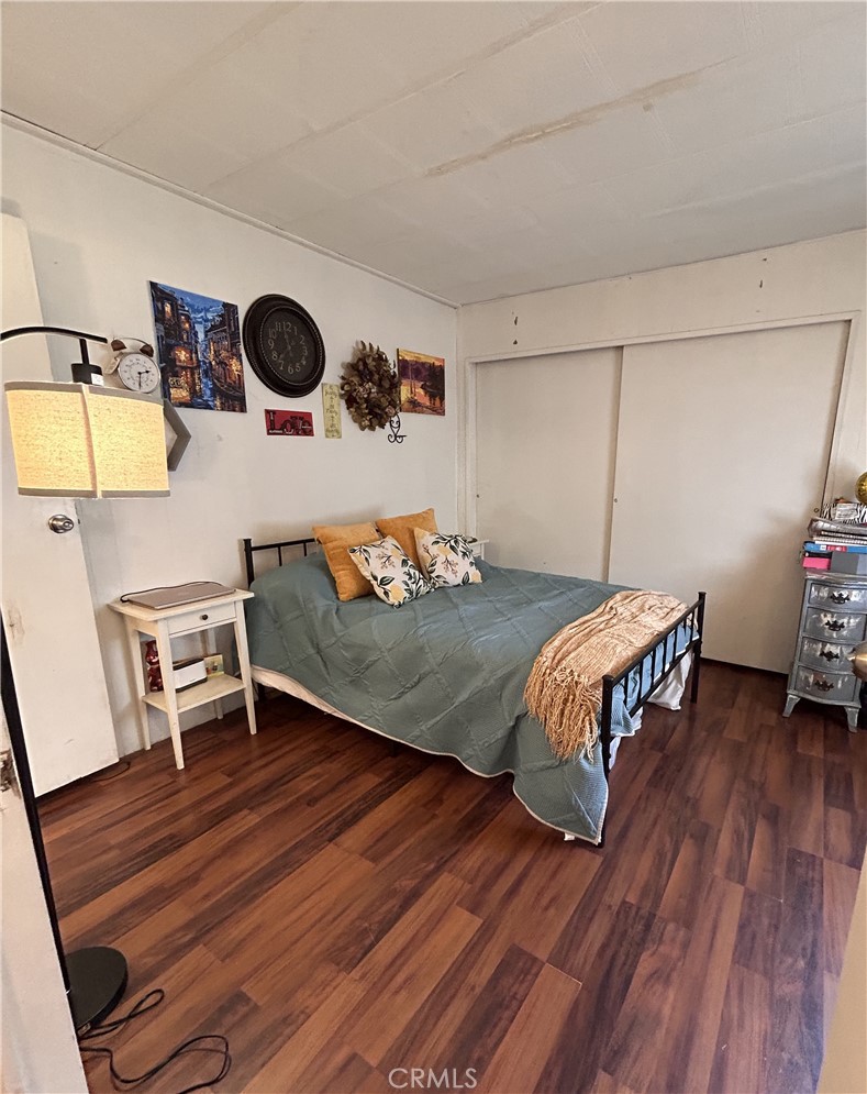 31816 Avenue E, Unit 135 Yucaipa, CA 92399 - Photo 11 of 12 a bedroom with a bed and a table in it