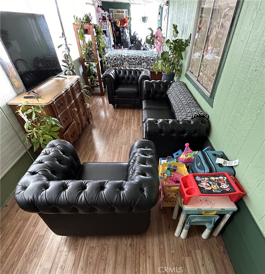 31816 Avenue E, Unit 135 Yucaipa, CA 92399 - Photo 12 of 12 a living room with furniture and a wooden floor