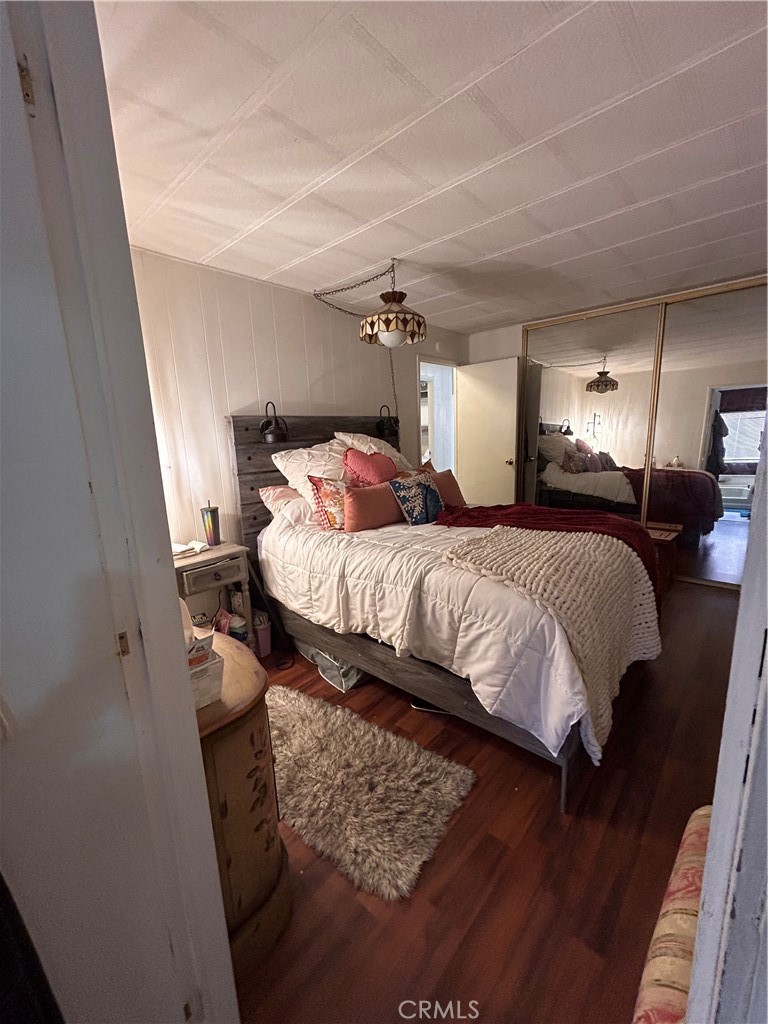 31816 Avenue E, Unit 135 Yucaipa, CA 92399 - Photo 8 of 12 a bedroom with a bed and a night stand