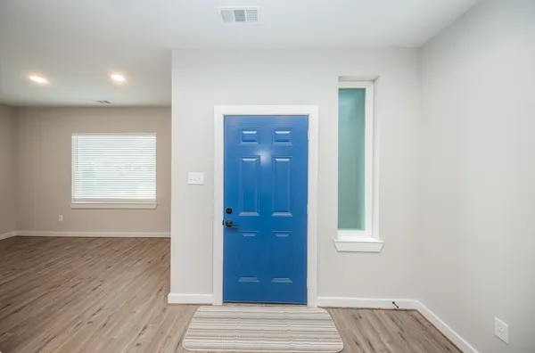 a view of front door with wooden floor