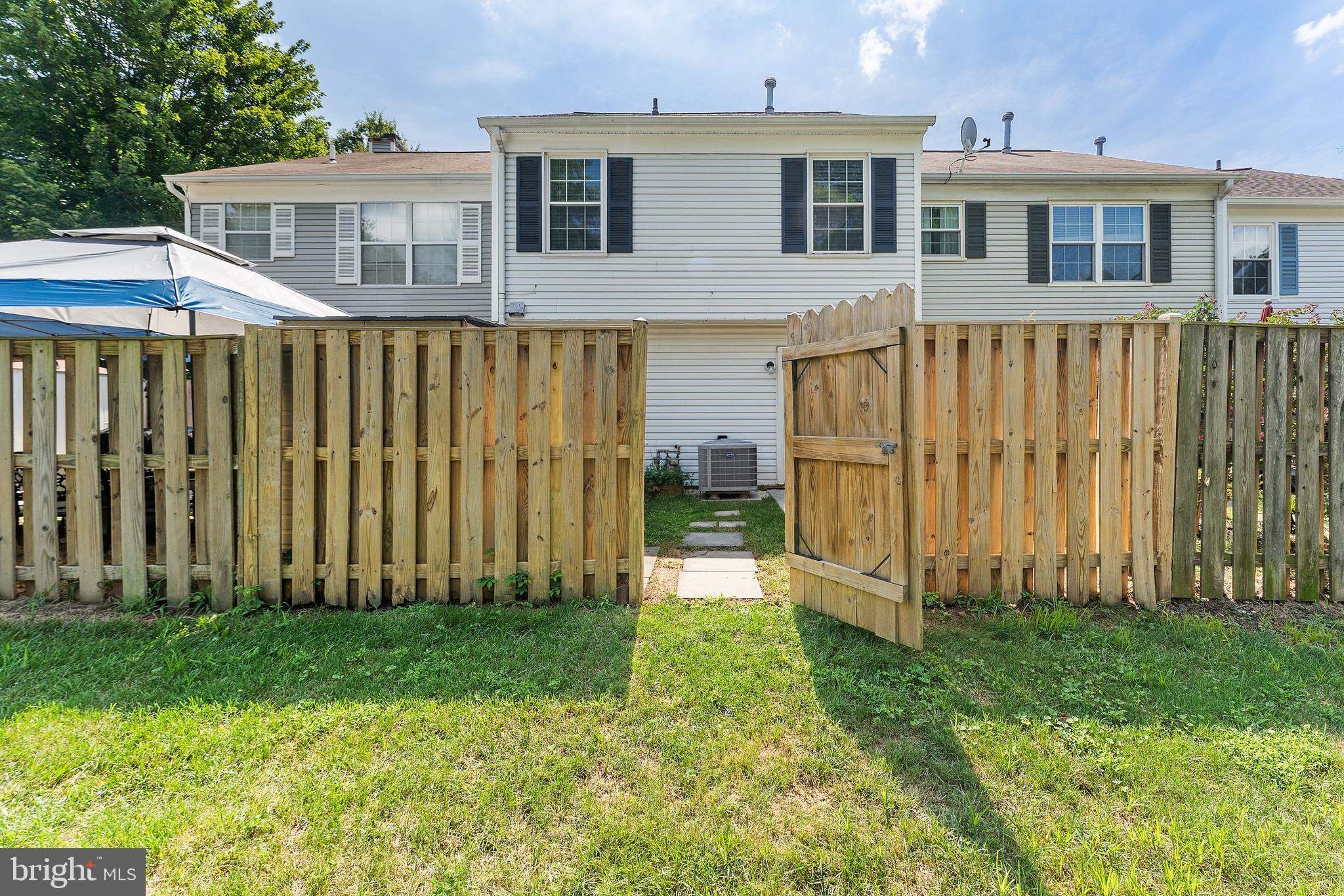 892 Smartts Lane Northeast Leesburg, VA 20176 - Photo 19 of 23 a front view of a house with a garden