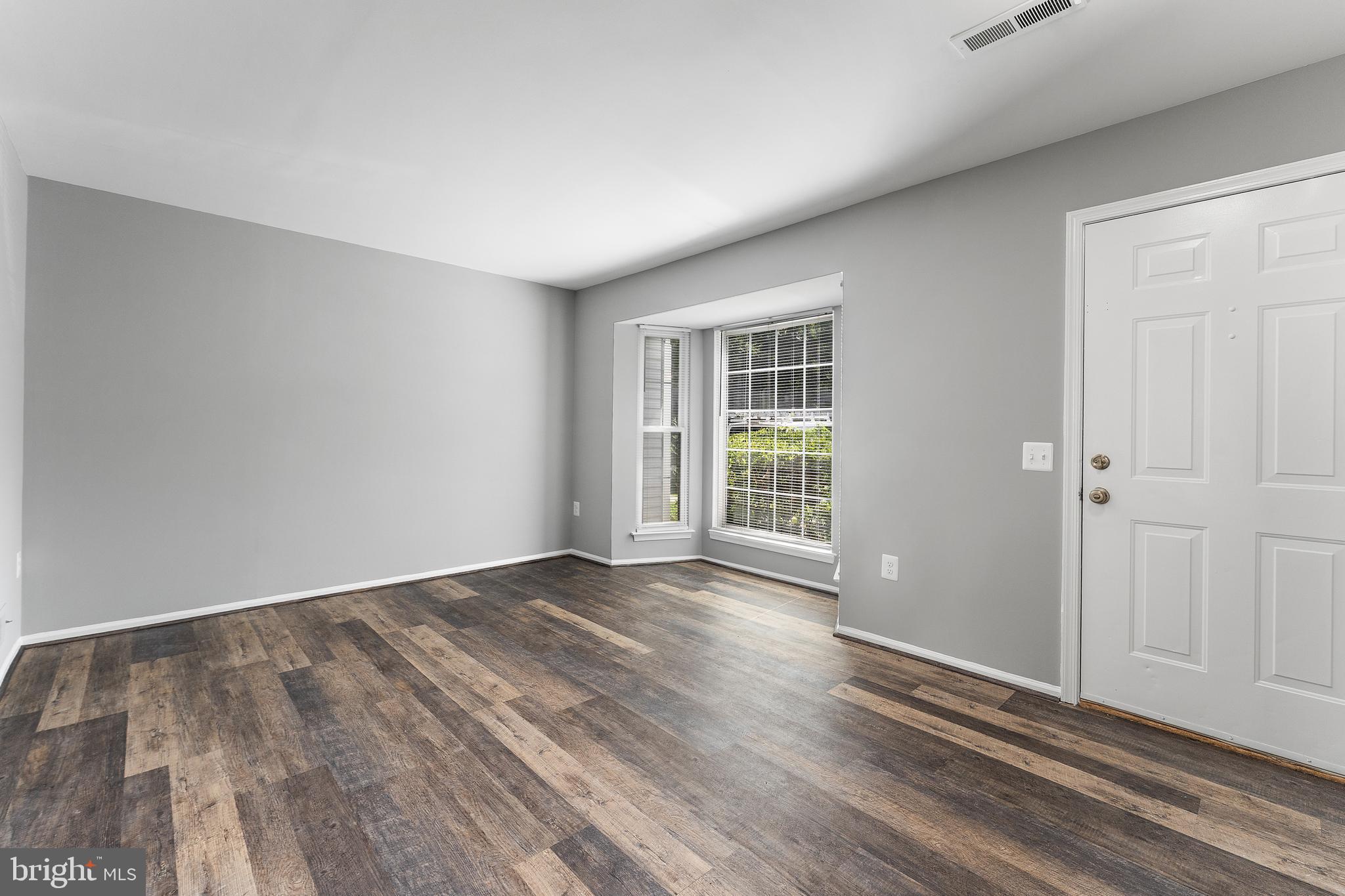 892 Smartts Lane Northeast Leesburg, VA 20176 - Photo 3 of 23 a view of an empty room with wooden floor and a window