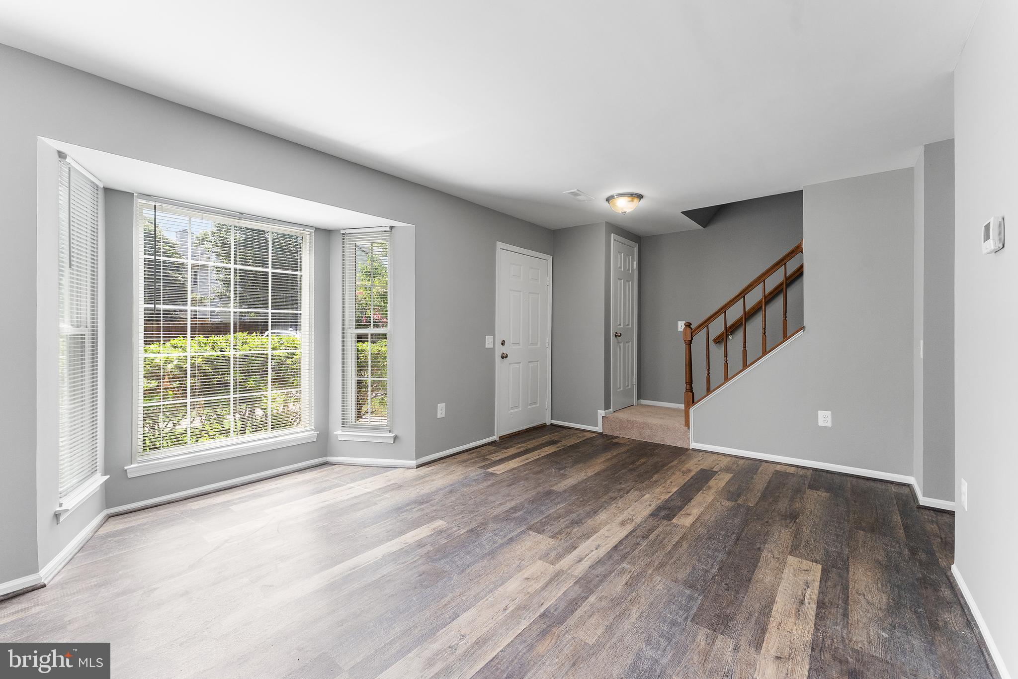 892 Smartts Lane Northeast Leesburg, VA 20176 - Photo 4 of 23 a view of an empty room with wooden floor and a window