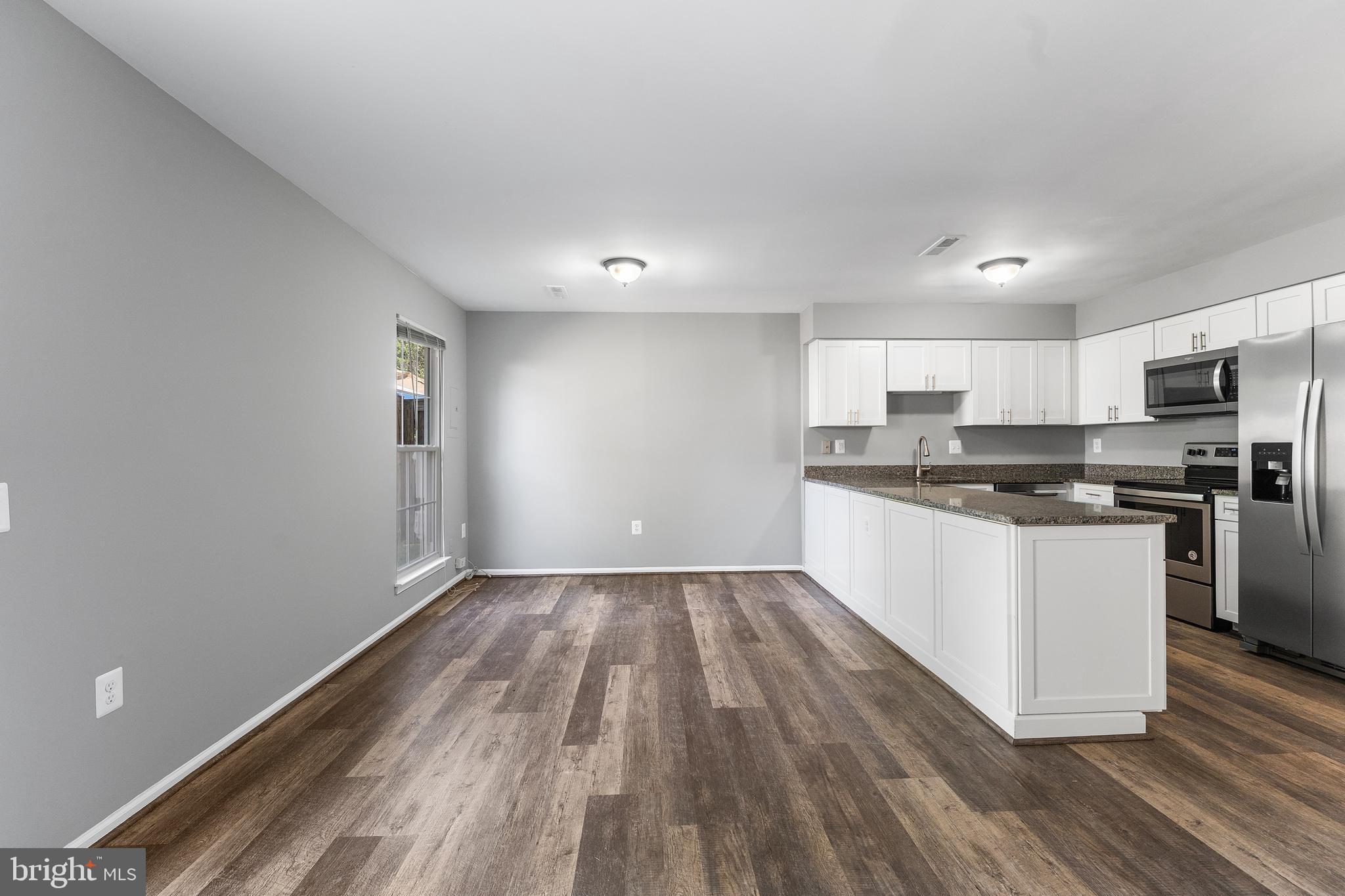 892 Smartts Lane Northeast Leesburg, VA 20176 - Photo 9 of 23 a kitchen with wooden floors and white appliances