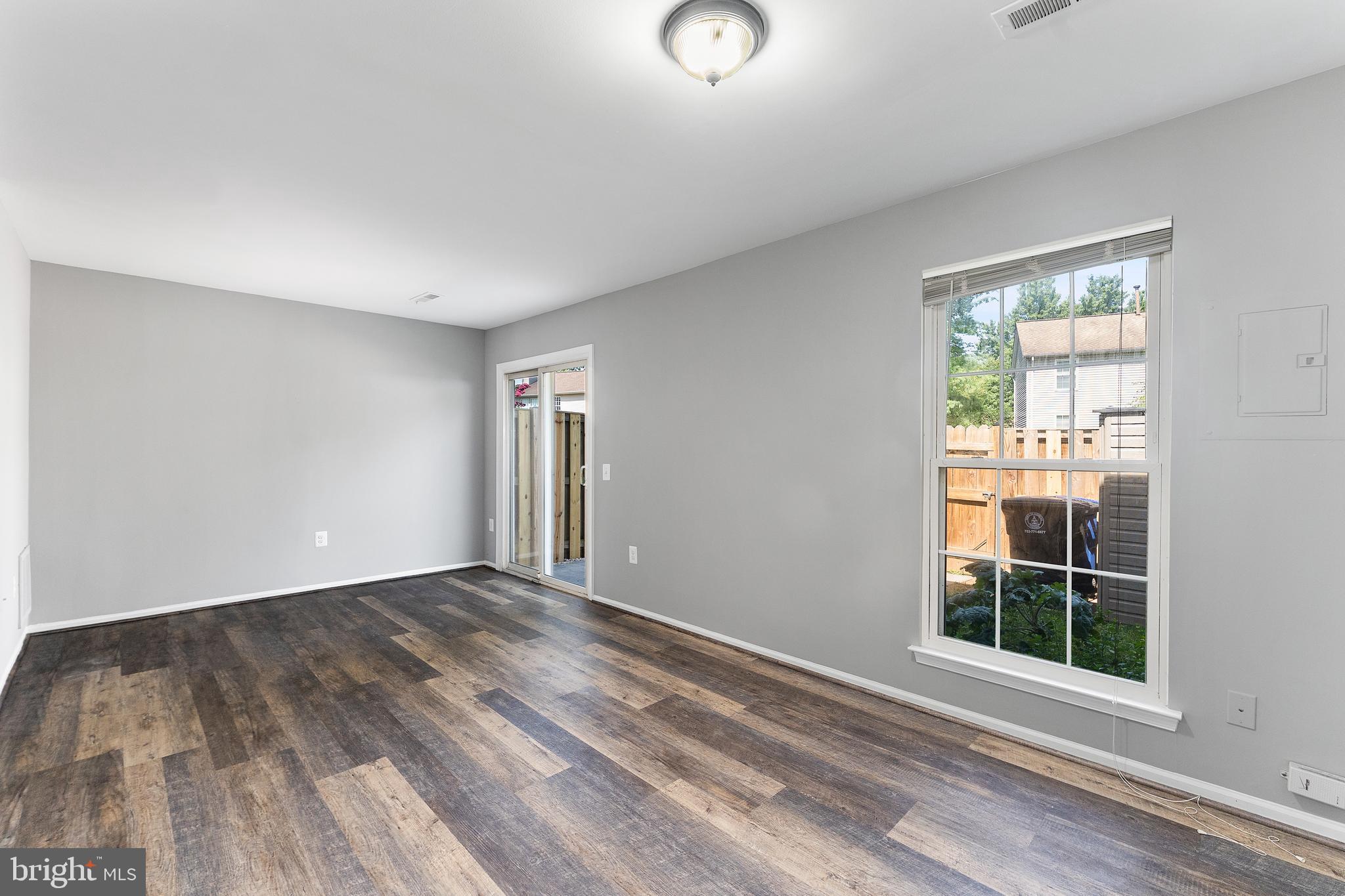 892 Smartts Lane Northeast Leesburg, VA 20176 - Photo 10 of 23 a view of an empty room with wooden floor and a window