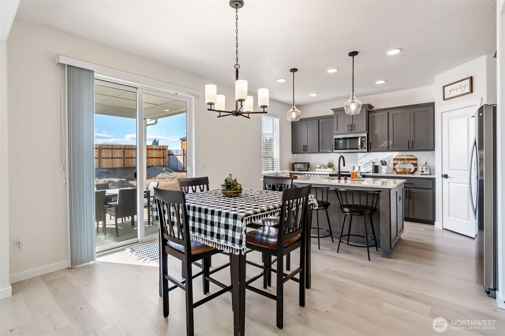 707 Cardinal Avenue Winlock, WA 98596 - Photo 11 of 36 a view of a dining room and livingroom with furniture wooden floor a chandelier