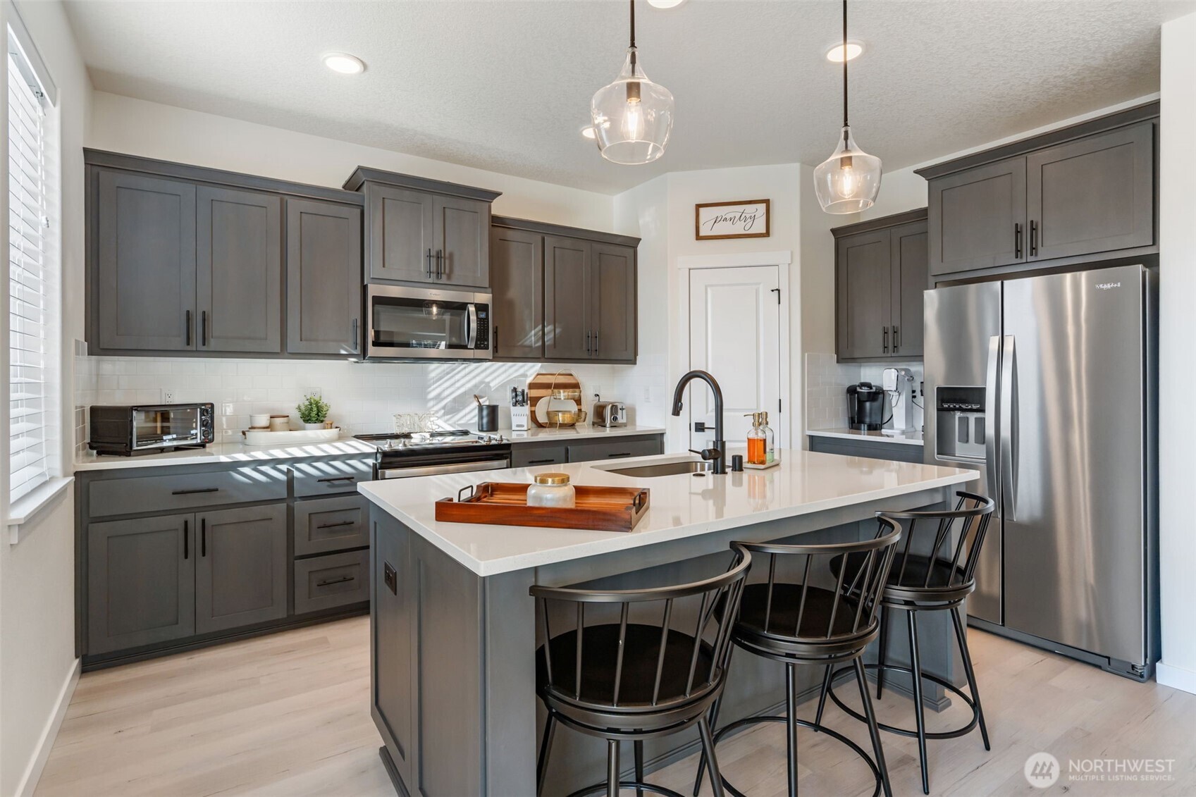 707 Cardinal Avenue Winlock, WA 98596 - Photo 13 of 36 a kitchen with stainless steel appliances a stove a sink a refrigerator and a center island