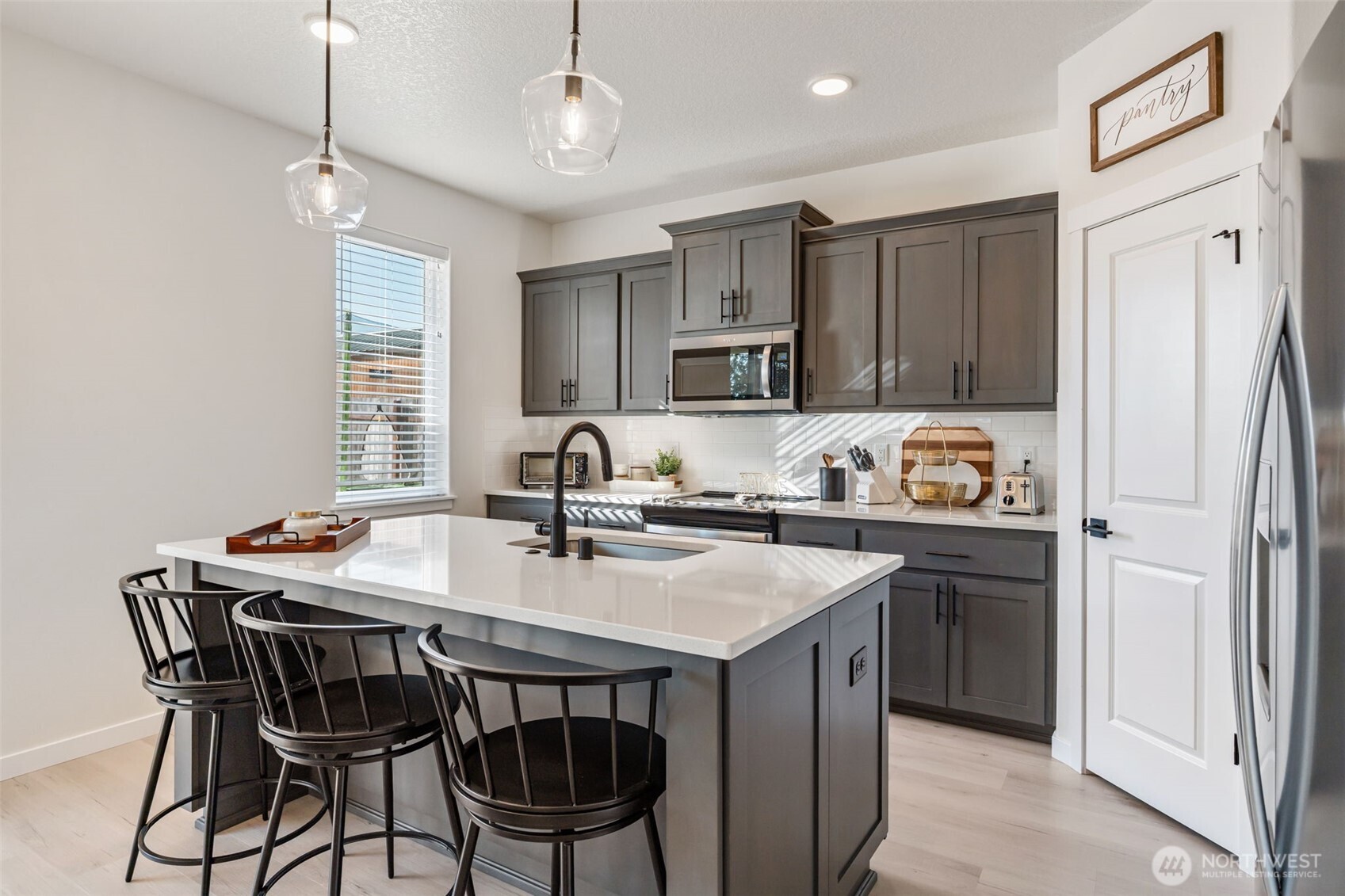 707 Cardinal Avenue Winlock, WA 98596 - Photo 14 of 36 a kitchen with stainless steel appliances granite countertop a sink a stove a refrigerator cabinets and chairs
