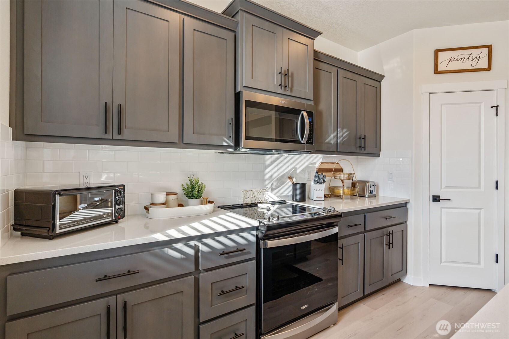 707 Cardinal Avenue Winlock, WA 98596 - Photo 15 of 36 a kitchen with granite countertop cabinets stainless steel appliances and wooden cabinets