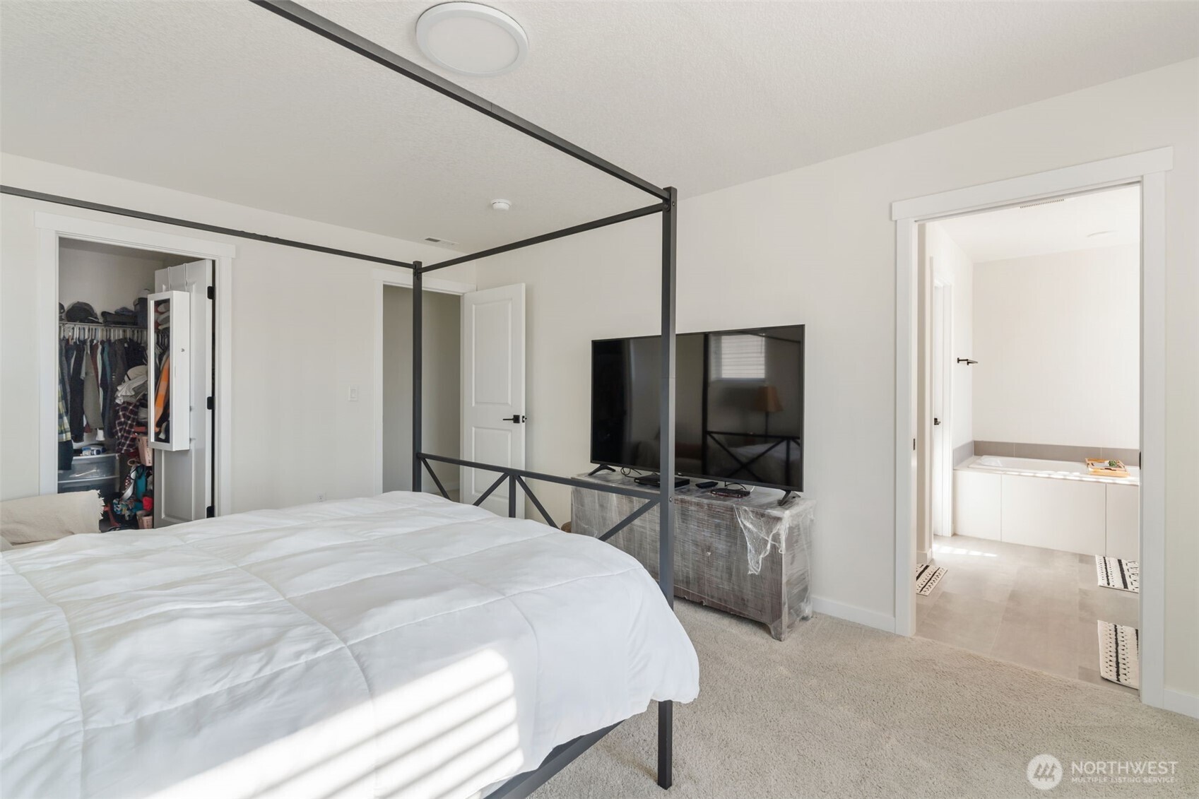 707 Cardinal Avenue Winlock, WA 98596 - Photo 18 of 36 a bedroom with a bed and a flat tv screen on wall