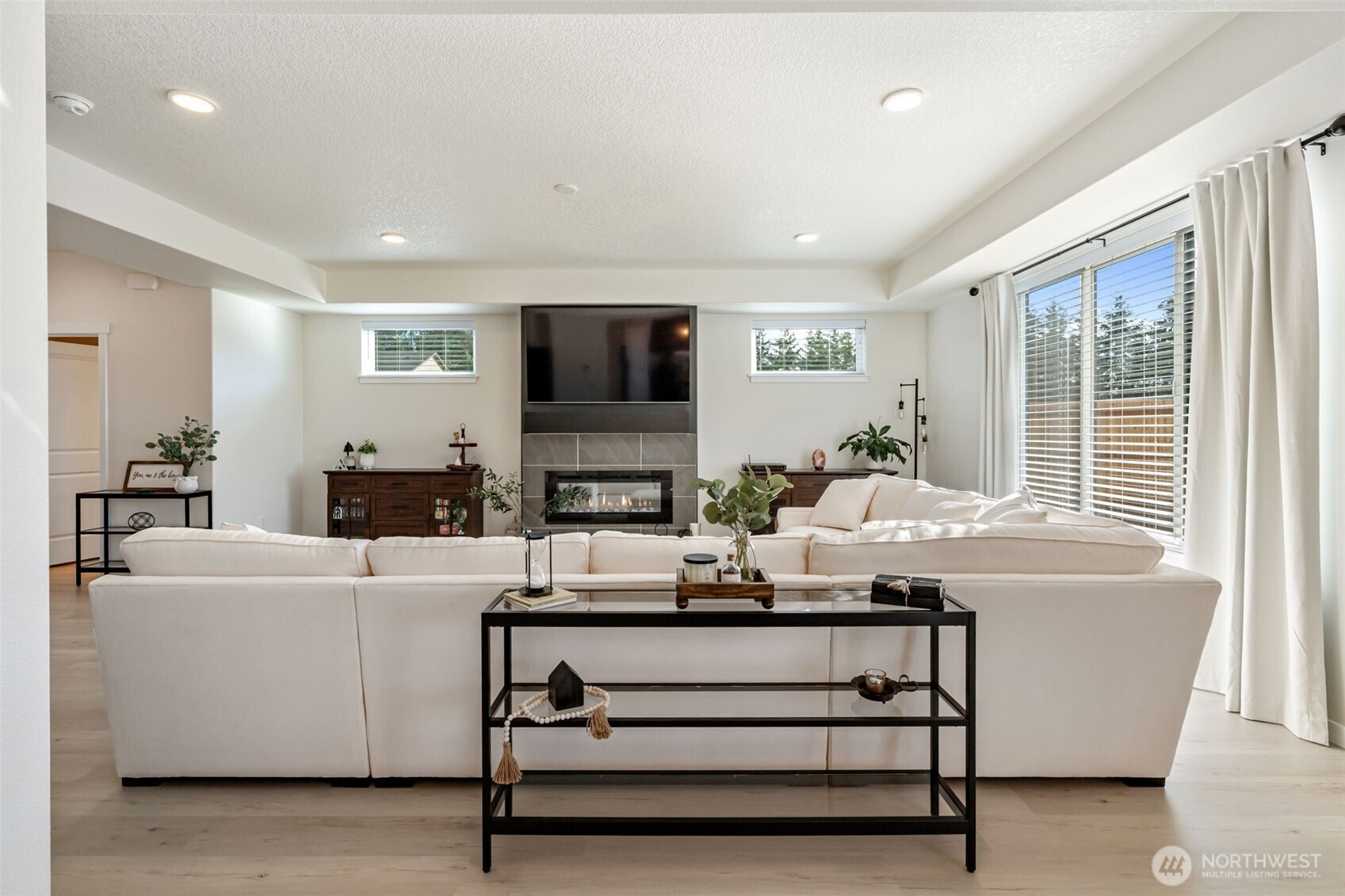 707 Cardinal Avenue Winlock, WA 98596 - Photo 6 of 36 a living room with furniture a flat screen tv and a fireplace