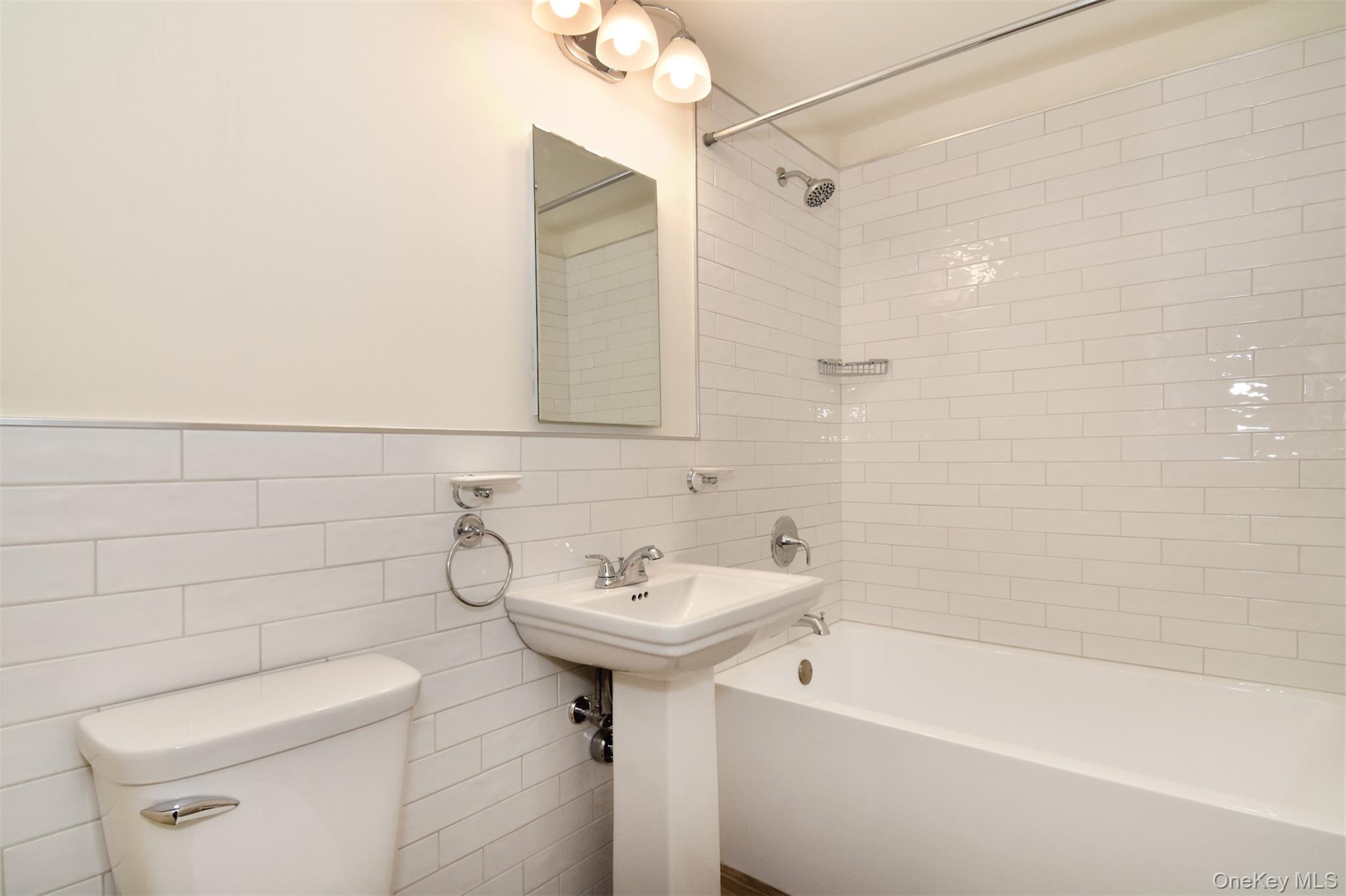 74 Briary Road Dobbs Ferry, NY 10522 - Photo 14 of 19 Hallway bath, newly renovated with modern flooring and subway tile.