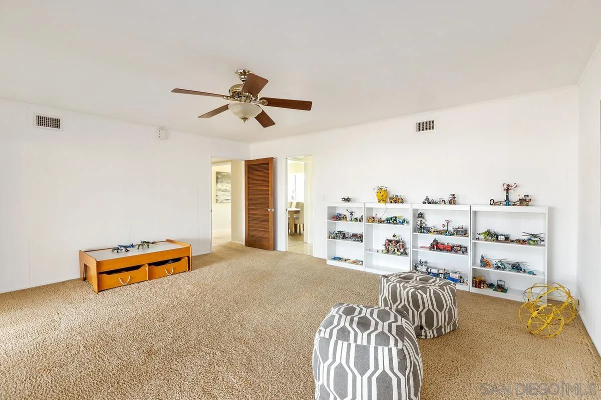 2075 Windmill View Road El Cajon, CA 92020 - Photo 23 of 34 a bedroom with furniture and a chair