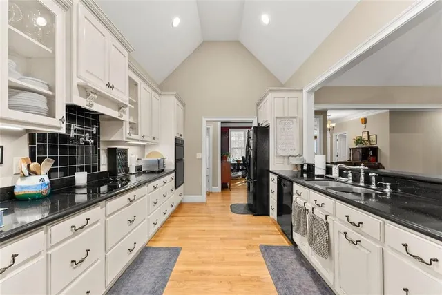 a kitchen with stainless steel appliances granite countertop a stove a refrigerator and microwave