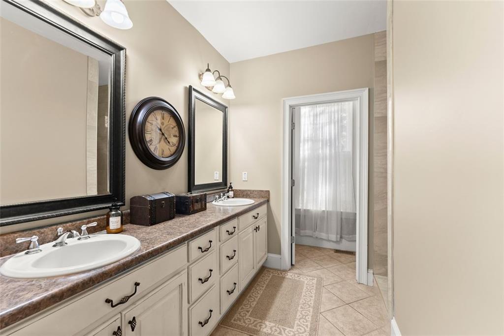 7269 Sloan Stephens Road Alto, GA 30510 - Photo 26 of 70 a bathroom with a double vanity sink and a mirror