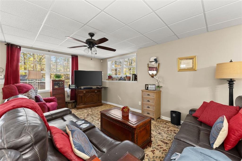 7269 Sloan Stephens Road Alto, GA 30510 - Photo 39 of 70 a living room with furniture a flat screen tv and a chandelier