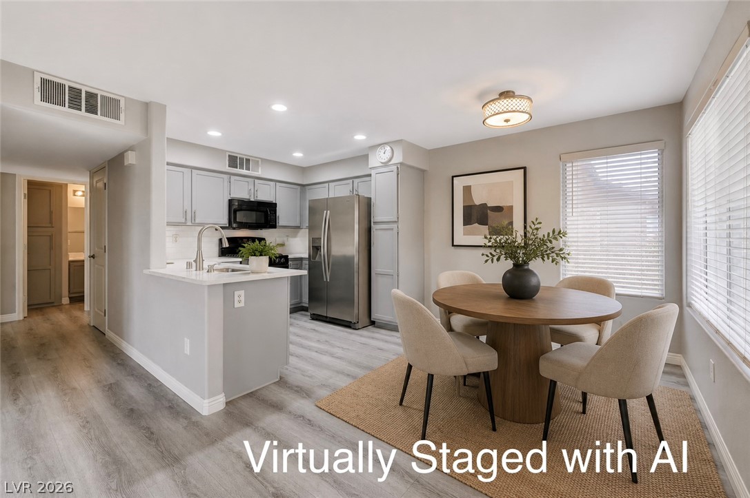3425 East Russell Road, Unit 223 Las Vegas, NV 89120 - Photo 5 of 47 Prepare meals in a kitchen equipped with modern appliances and an inviting breakfast bar.