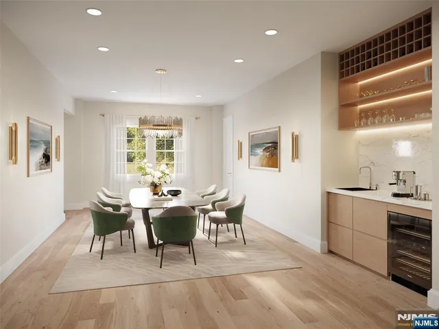 a dining room with wooden floor and white walls
