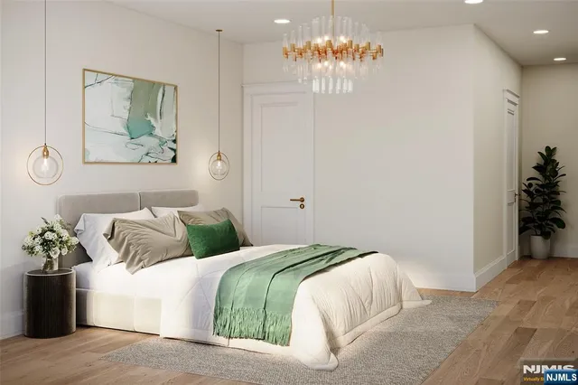 a bedroom with a bed and a chandelier