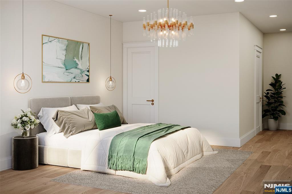 42 Werimus Road Woodcliff Lake, NJ 07677 - Photo 9 of 11 a bedroom with a bed and a chandelier