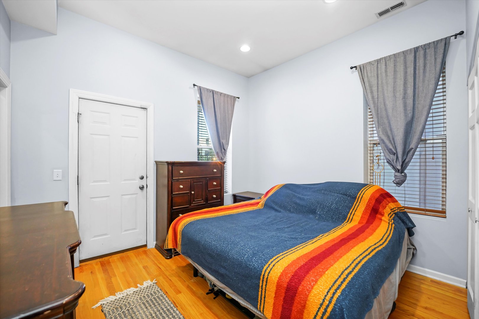 2744 West Haddon Avenue, Unit 2 Chicago, IL 60622 - Photo 12 of 22 a bedroom with a bed and wooden floor