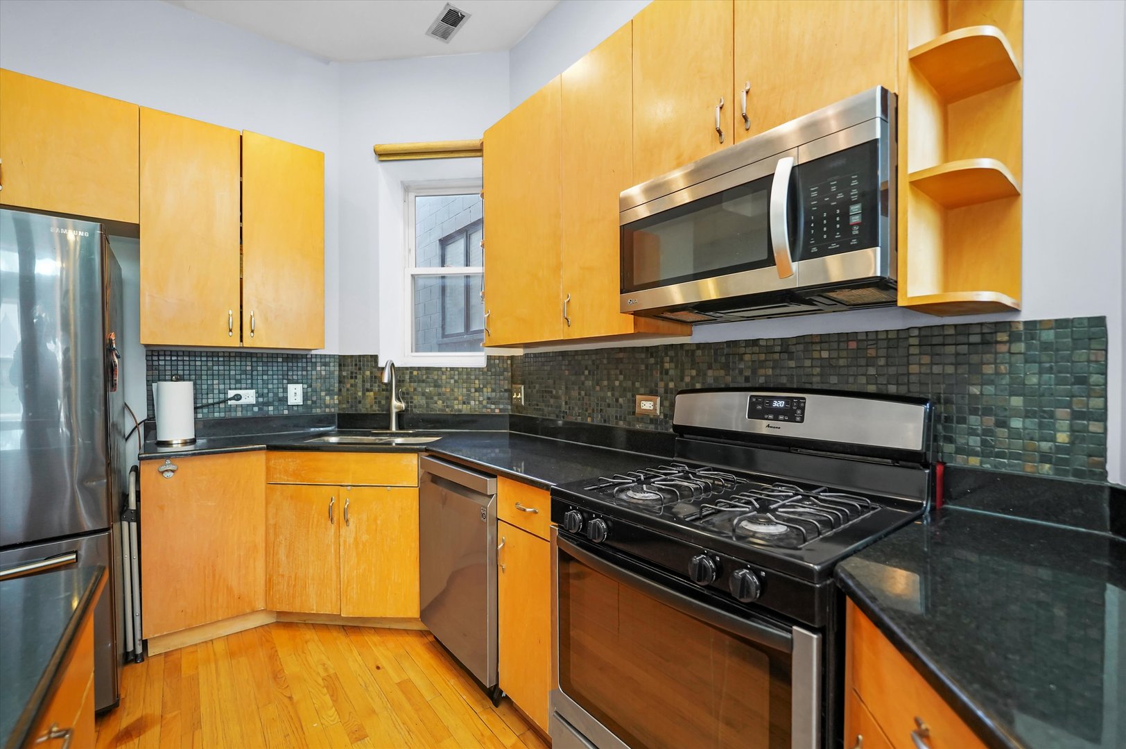 2744 West Haddon Avenue, Unit 2 Chicago, IL 60622 - Photo 3 of 22 a kitchen with a stove a sink and a microwave