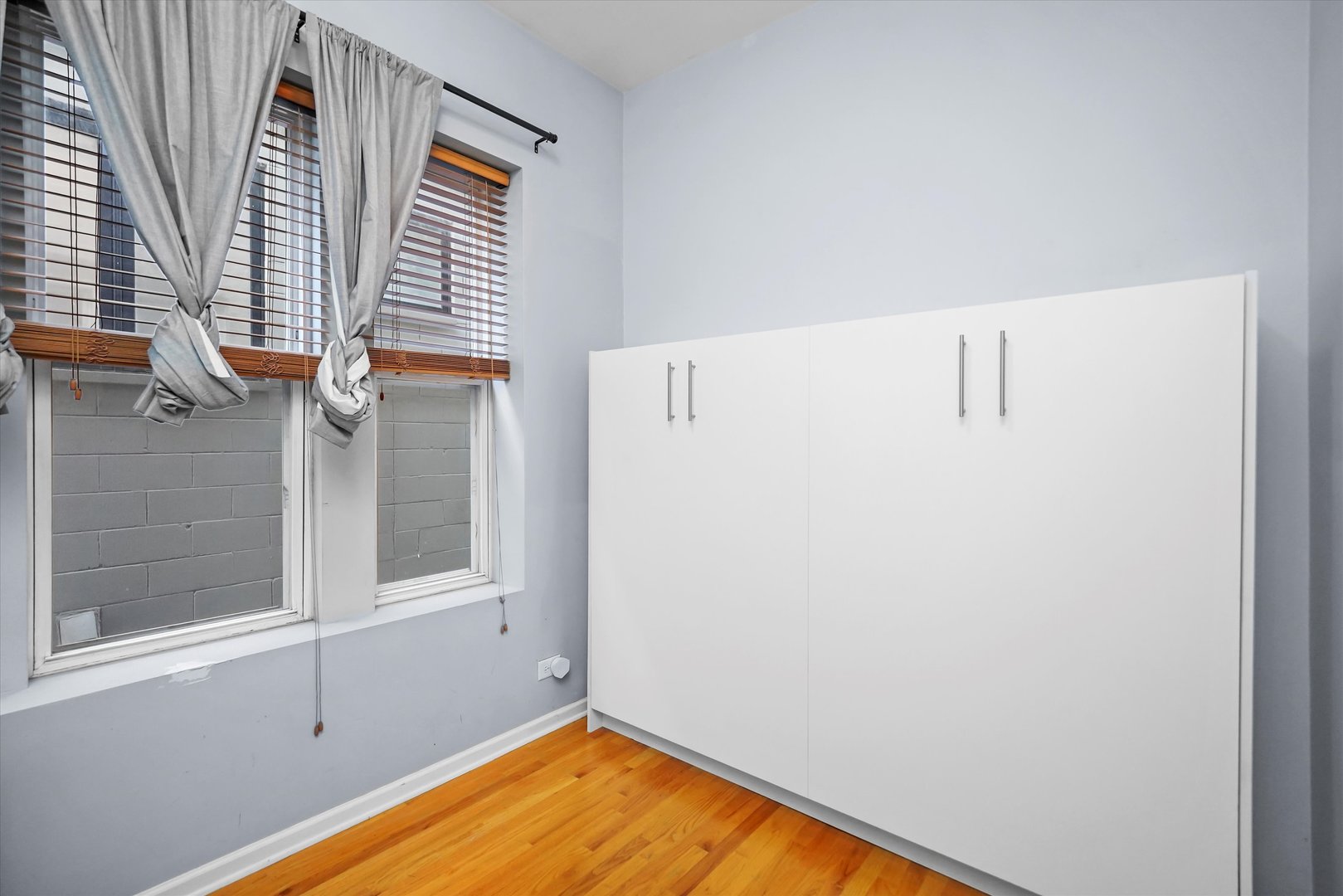 2744 West Haddon Avenue, Unit 2 Chicago, IL 60622 - Photo 9 of 22 a view of a room with wooden floor and cabinet