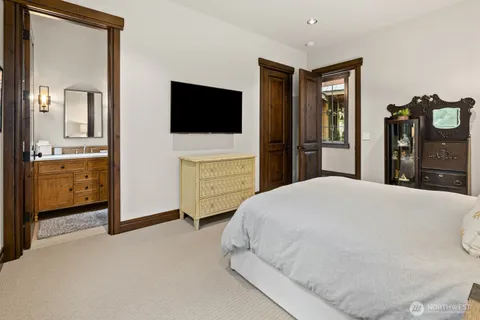 a bedroom with a bed and a television