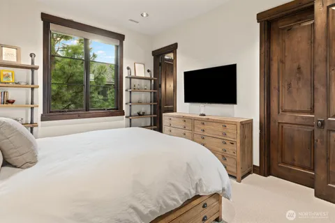 a bedroom with a bed and a flat screen tv