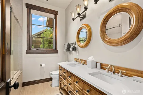 a bathroom with a toilet a sink and a mirror