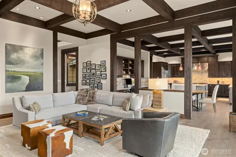 a living room with furniture and a chandelier