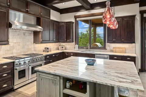 a kitchen with a stove a sink and a window
