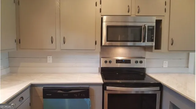 a stove top oven sitting inside of a kitchen
