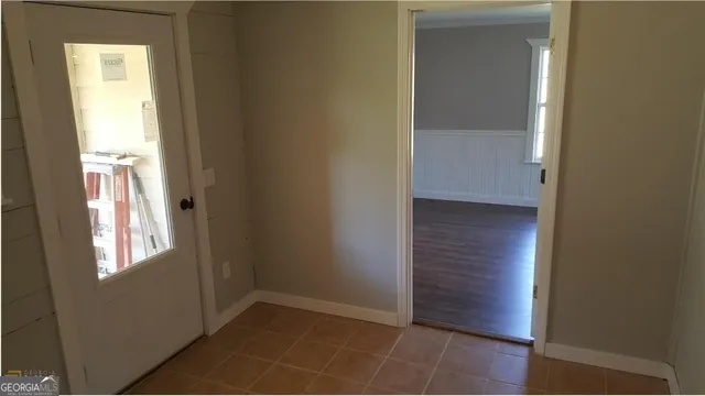 an empty room with windows and closet