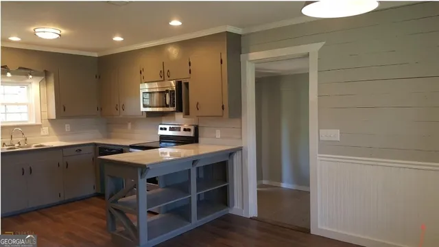 a kitchen with stainless steel appliances granite countertop a sink and a stove top oven