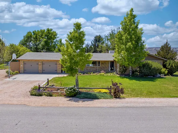 a front view of a house with a garden and a yard