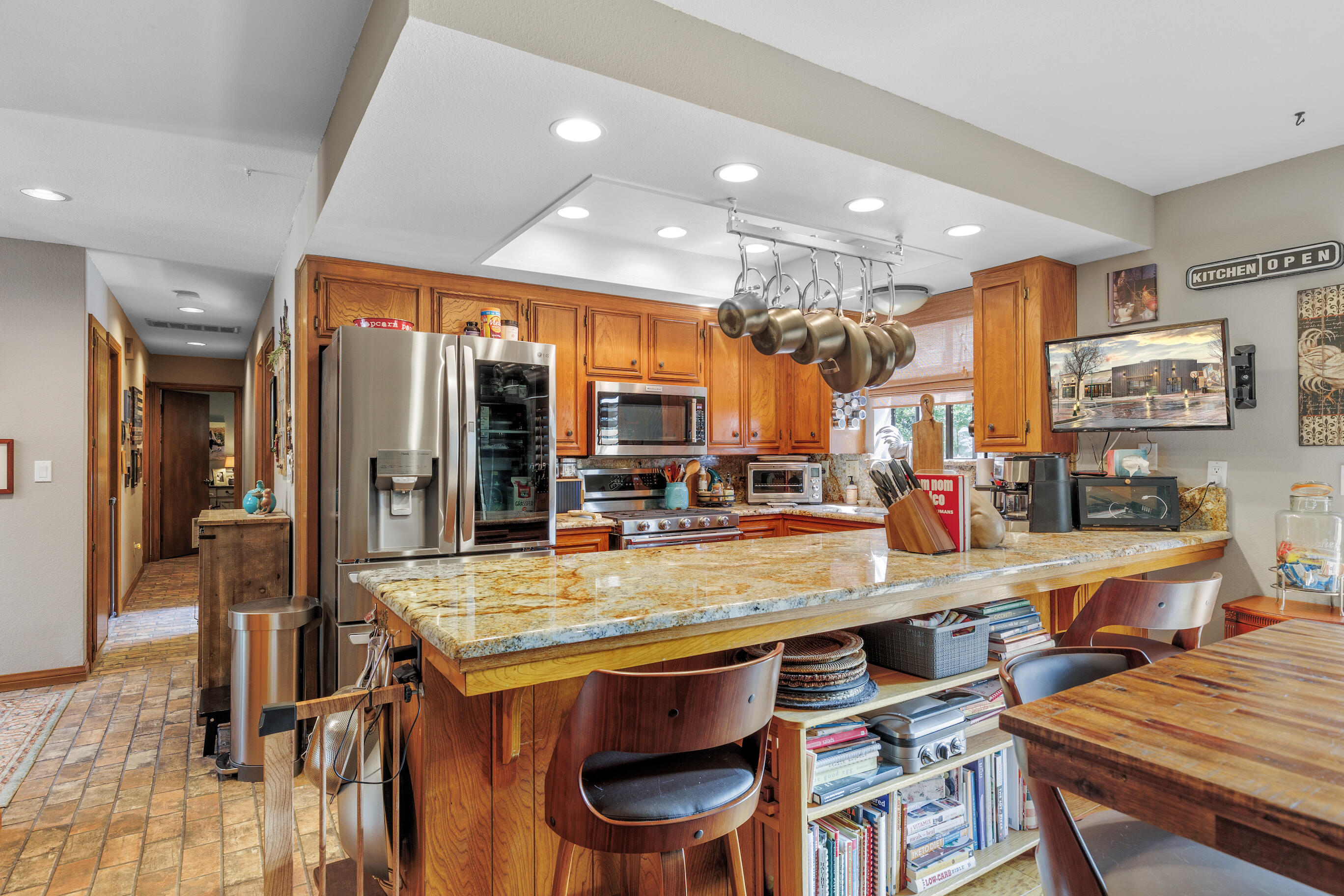26901 Bear Valley Road Tehachapi, CA 93561 - Photo 25 of 62 a room with stainless steel appliances lots of wooden furniture dining table and chairs