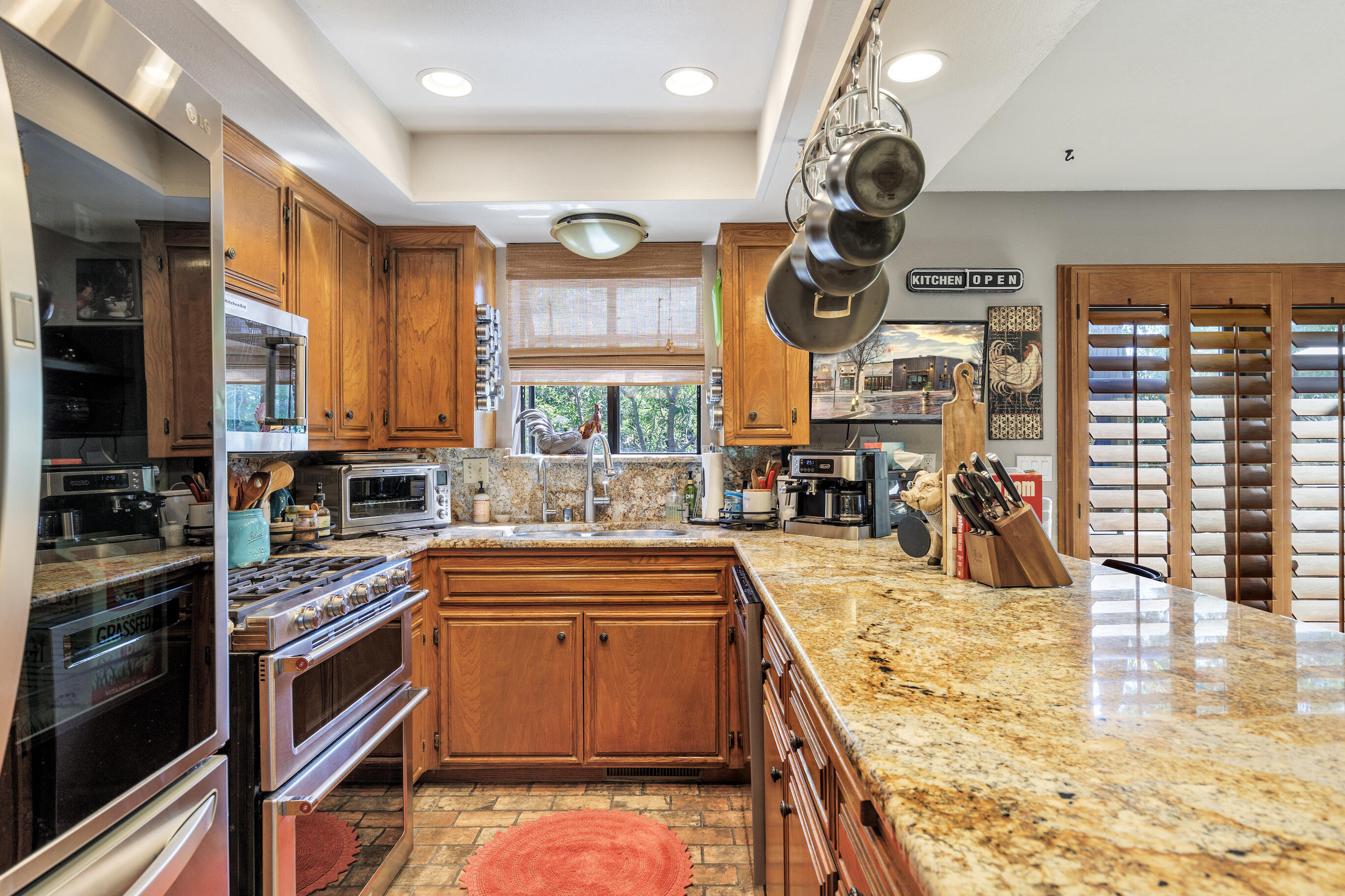 26901 Bear Valley Road Tehachapi, CA 93561 - Photo 26 of 62 a kitchen with stainless steel appliances granite countertop a stove a sink and a microwave