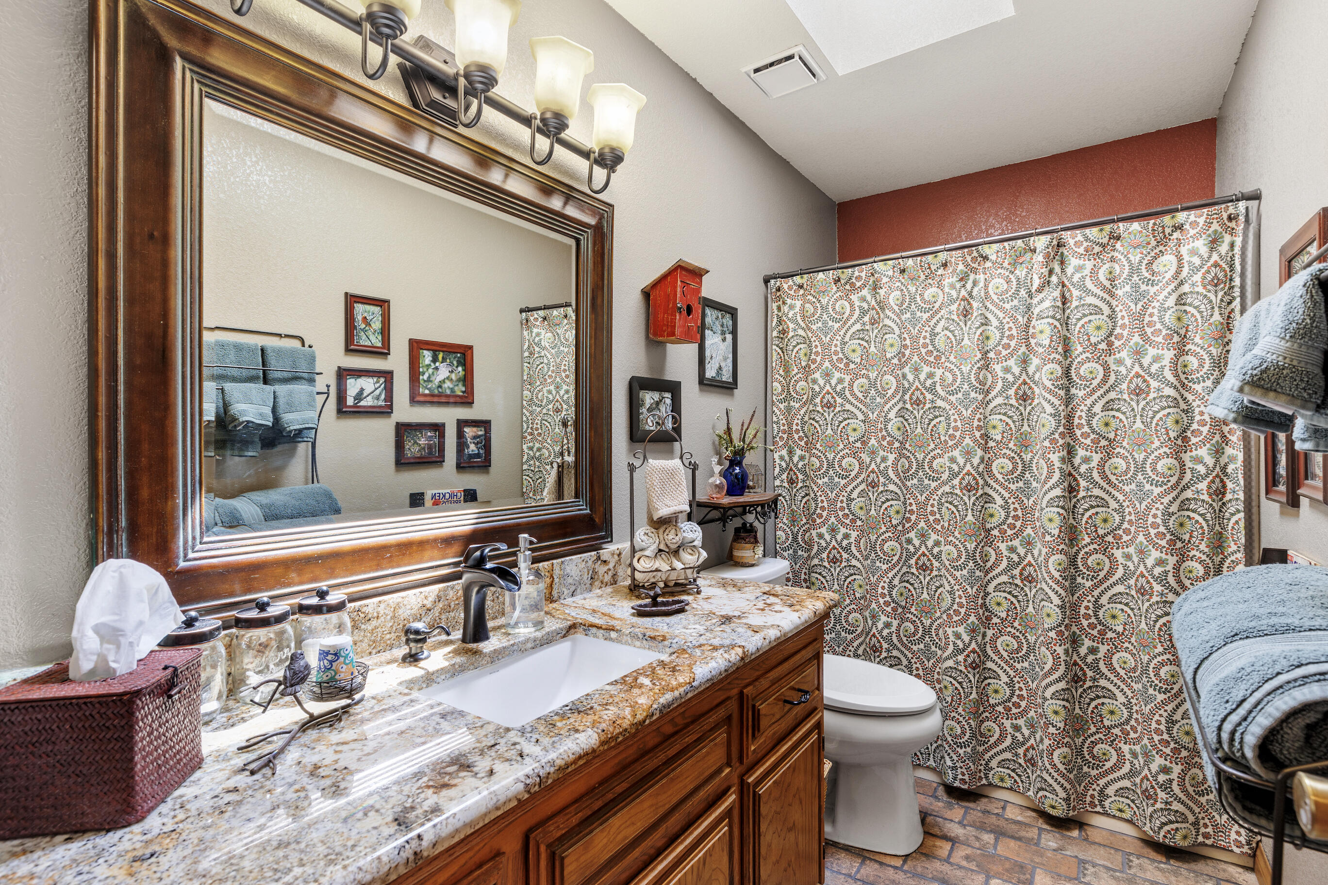 26901 Bear Valley Road Tehachapi, CA 93561 - Photo 30 of 62 a bathroom with a granite countertop double vanity sink mirror and toilet