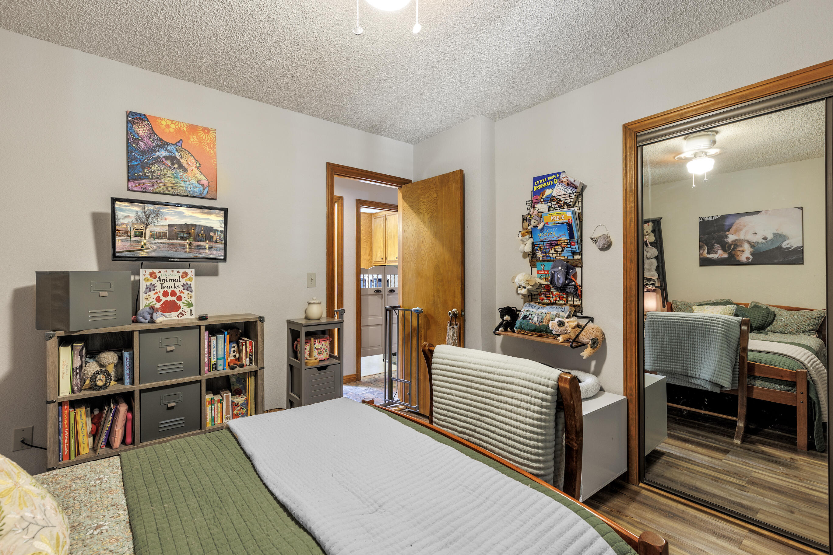 26901 Bear Valley Road Tehachapi, CA 93561 - Photo 32 of 62 a bedroom with furniture and a book shelf