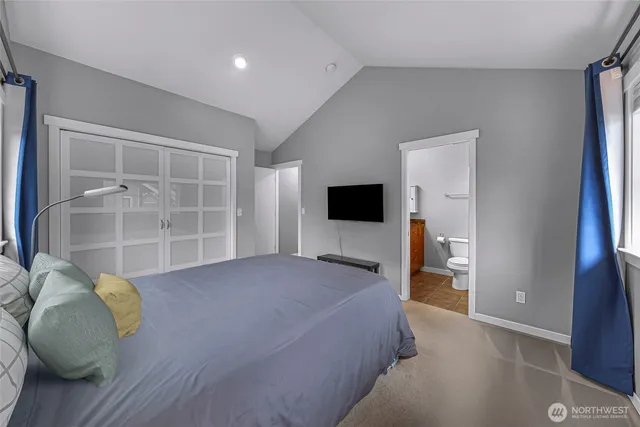 a bedroom with a bed and a television