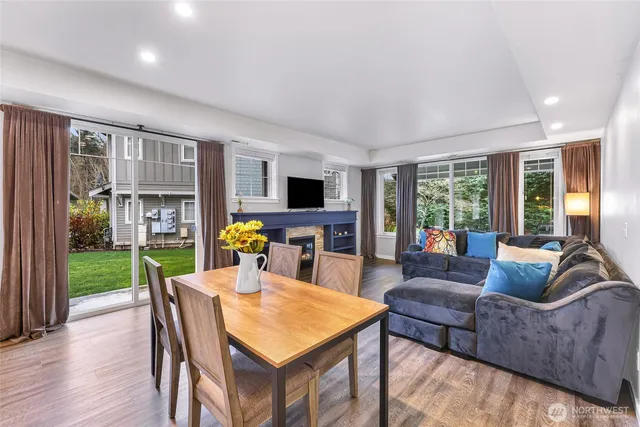 a living room with furniture a flat screen tv and a floor to ceiling window