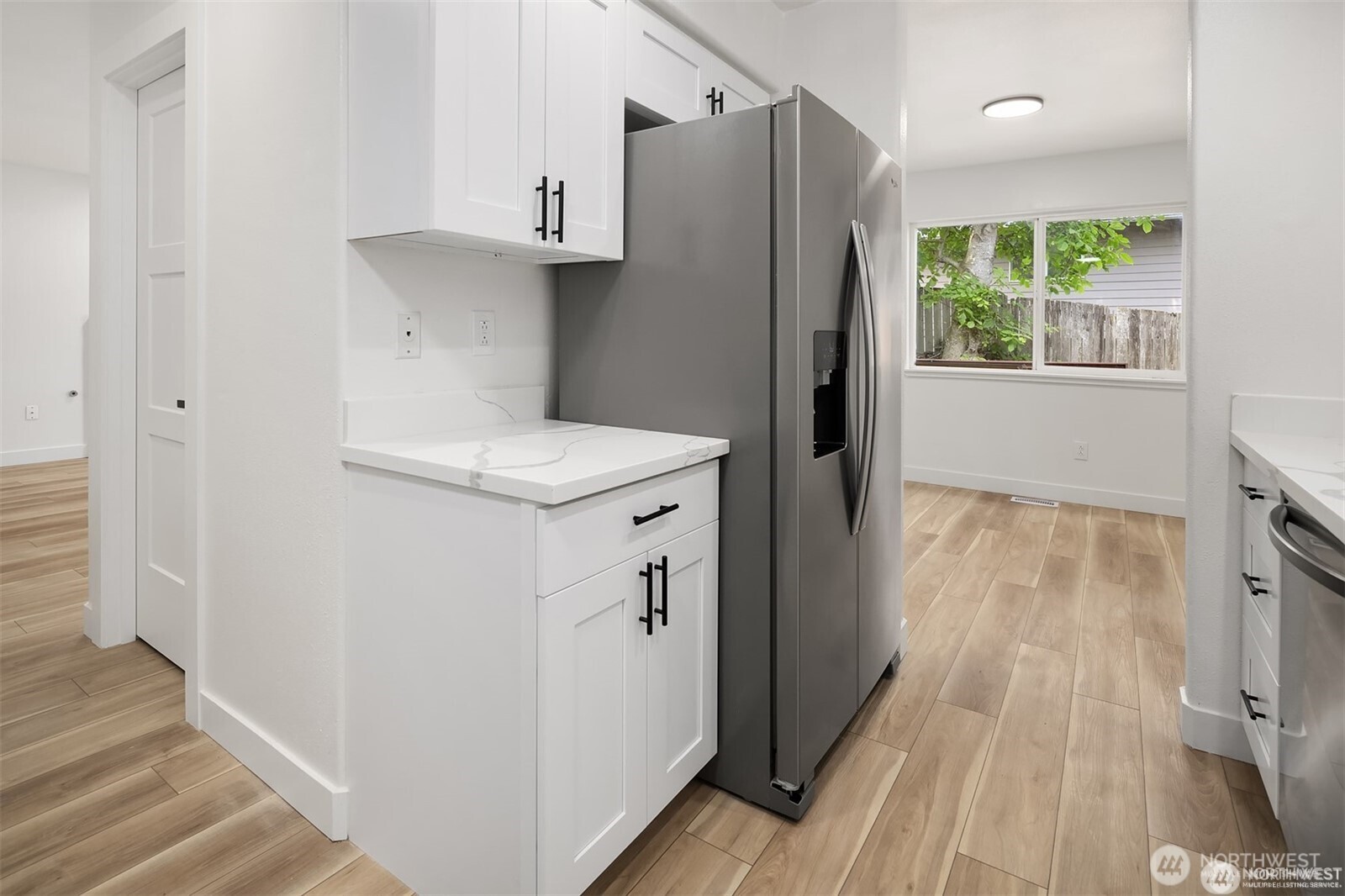 9 76th Street Southeast Everett, WA 98203 - Photo 13 of 28 a kitchen with a refrigerator a sink and wooden floor