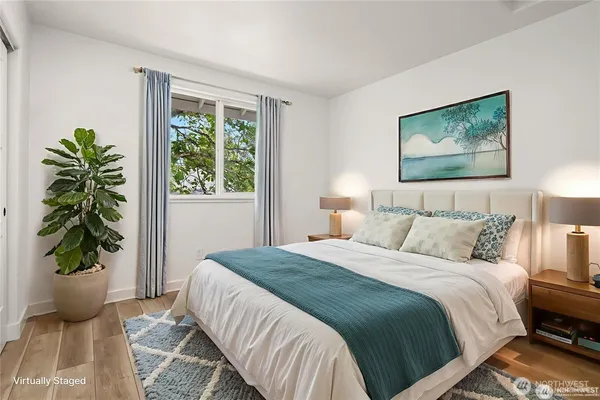 a bedroom with a bed and a painting on the wall