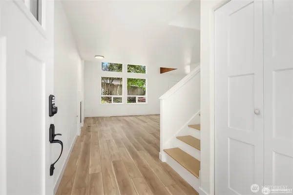 a view of a bedroom with wooden floor and staircase